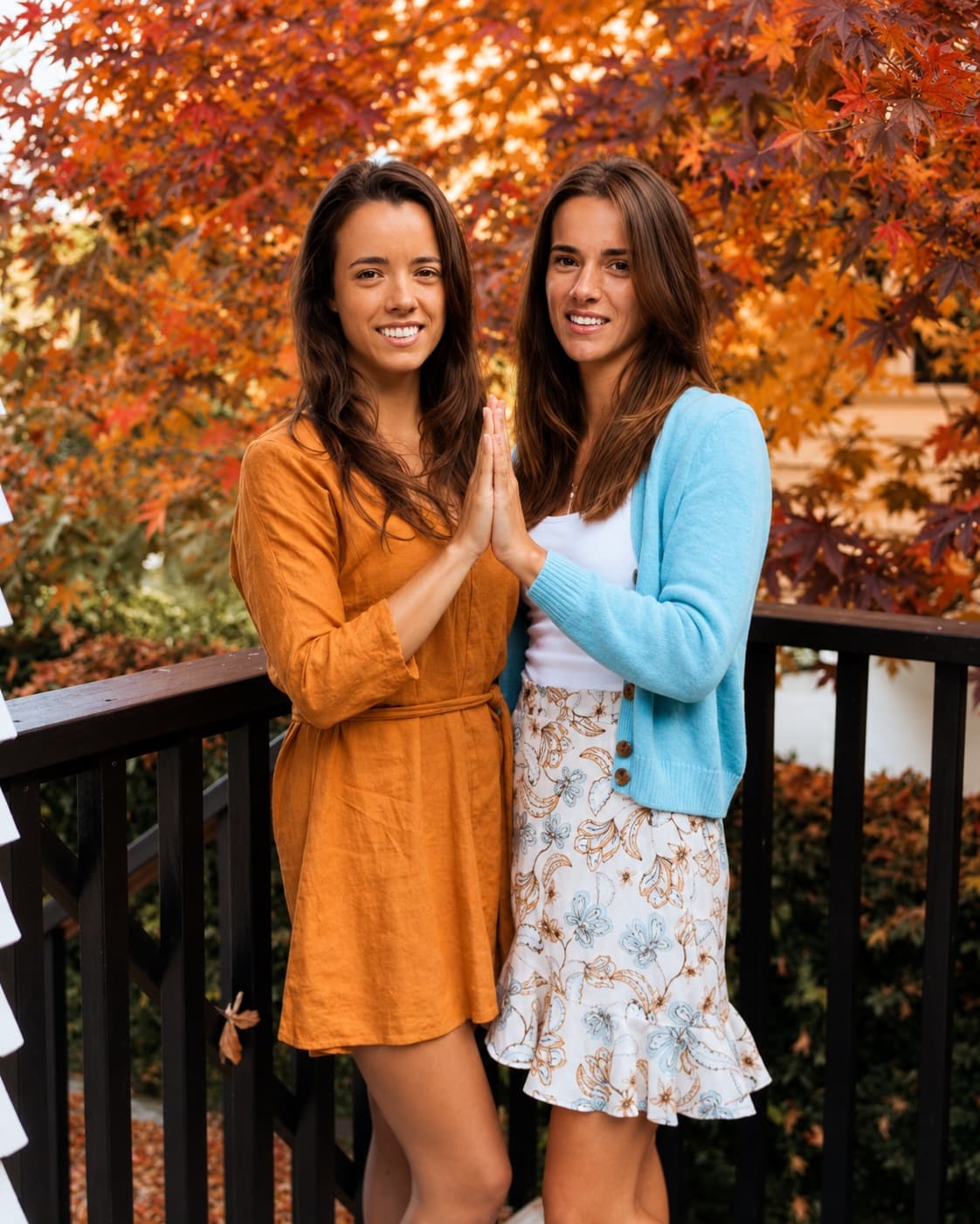 Sophia and Renee, the sisters behind Seven Sisters Cacao, palms pressed together beneath autumn leaves